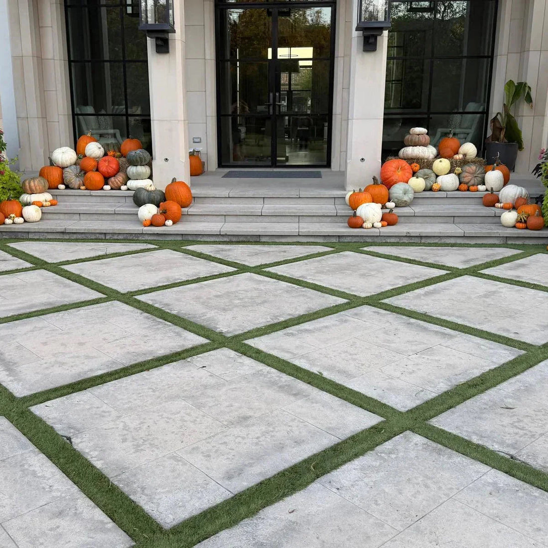Luxury pumpkin display on modern porch steps with stacked heirloom pumpkins for fall decor in Dallas–Fort Worth